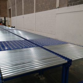 Gravity roller conveyor with ball table