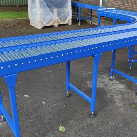 Twin lane gravity roller conveyor with bend