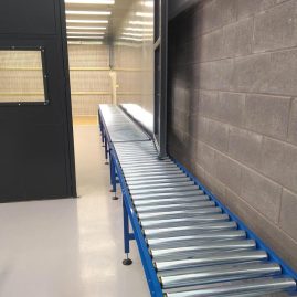 gravity roller conveyor built to fit under door