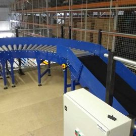 Mezzanine belt conveyor to roller conveyor bend